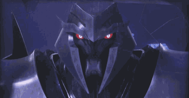 a close up of a robot with red eyes looking at the camera