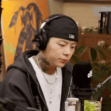 a man wearing headphones and a hat with the letter d on it