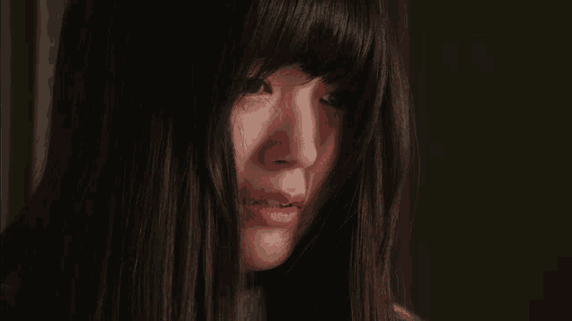 a close up of a woman 's face with tears running down her face
