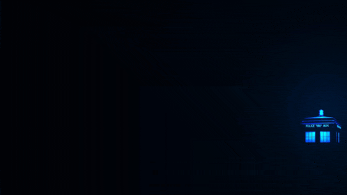 a police box is lit up in the dark with a blue light