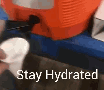a sign that says stay hydrated next to a cooler