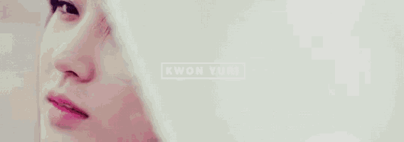 a close up of a woman 's face with the words kwon yuri written on it .