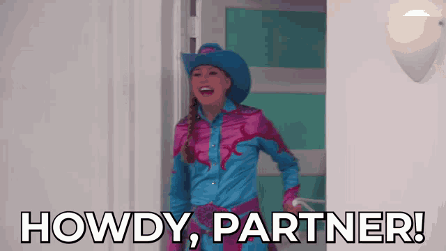 a woman in a cowboy outfit says howdy partner in a doorway