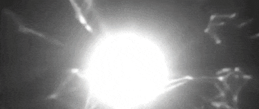 a black and white video of a light coming out of a sphere .