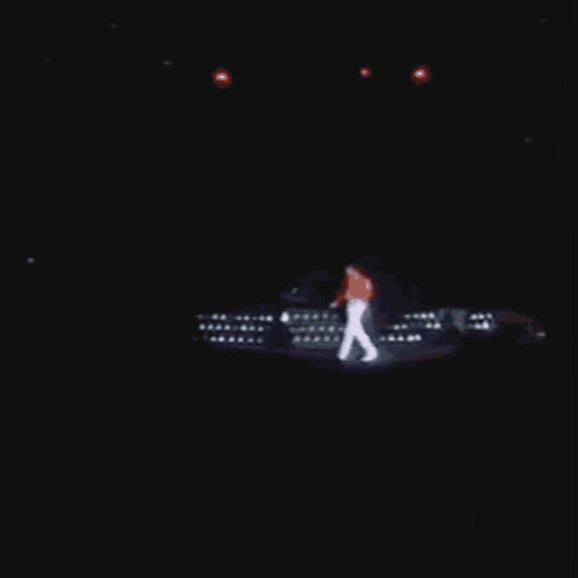 a close up of a person 's butt in white pants in a dark room