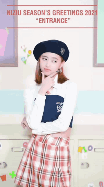 a girl wearing a plaid skirt and a beret stands in front of a sign that says niziu season 's greetings
