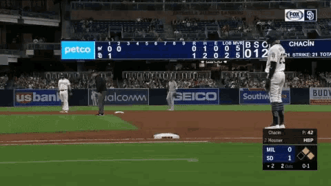 a baseball game is being played in a stadium with ads for petco and geico