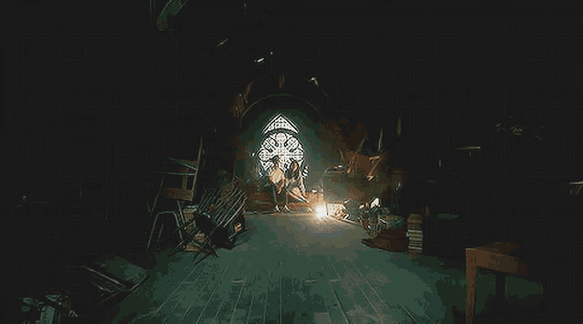 a very dark room with a stained glass window