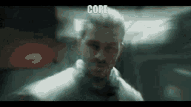 a close up of a man 's face with the word core written on it