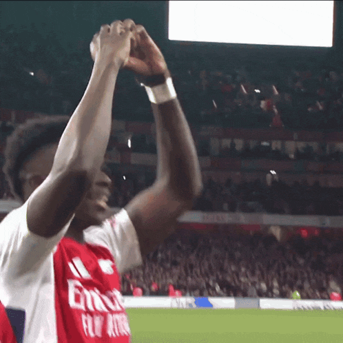 a soccer player wearing a fly emirates jersey