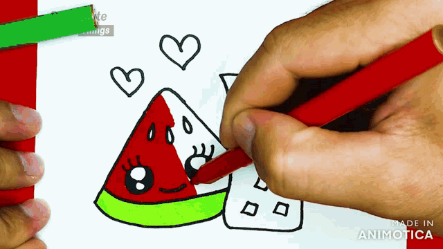 a person is drawing a slice of watermelon with a face on it