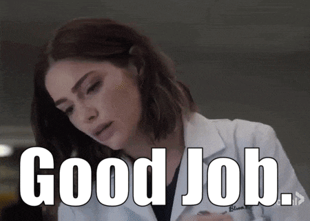 a woman in a lab coat is giving a good job .