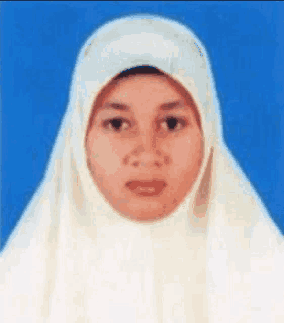 a woman wearing a white hijab is looking at the camera with a blue background .