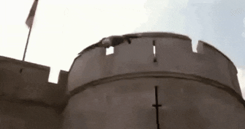 a man is jumping off the top of a castle tower .