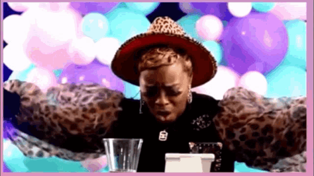 a woman wearing a leopard print shirt and a red hat
