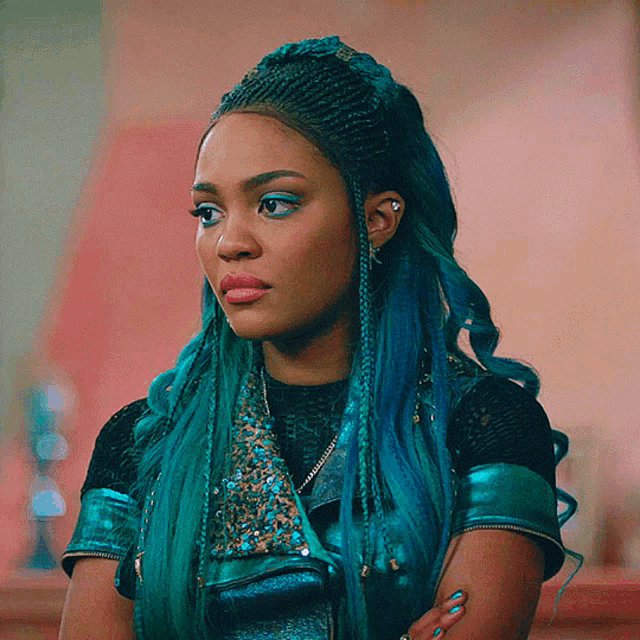 a woman with blue hair is wearing a leather jacket