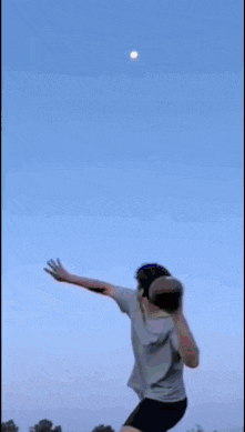 a boy is standing in front of a cloudy sky with a shooting star in the background