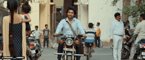a man is riding a motorcycle with a license plate that says tcrb 4705
