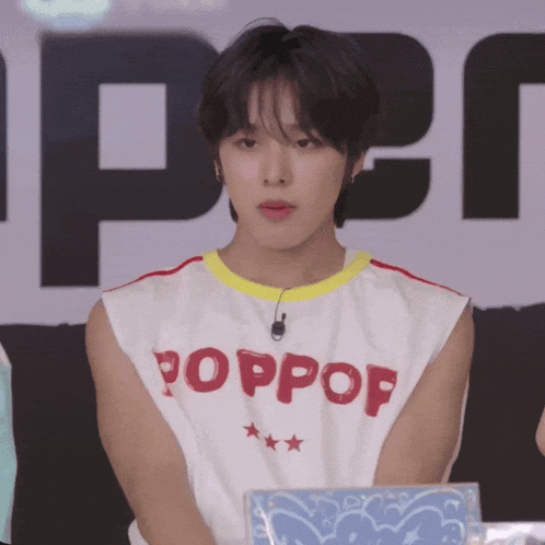 a young man wearing a white shirt that says poppop on it