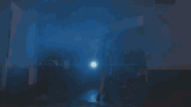 a person is walking through a dark room with a light shining through the smoke