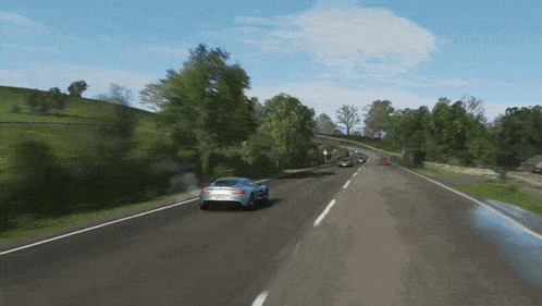 a car with a license plate that starts with the letter r is driving down a road