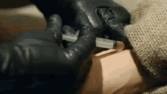 a person is holding a syringe in their hand .