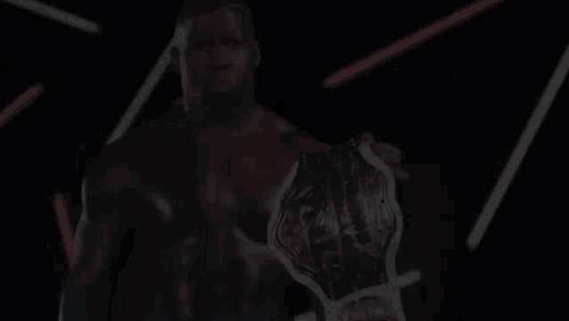 a shirtless man is holding a world heavyweight championship belt