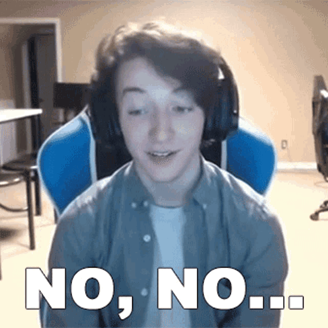 a young man wearing headphones is sitting in a blue chair and saying no , no , no ..