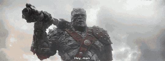 a giant rock monster is holding a gun in his hand and saying `` hey , man '' .