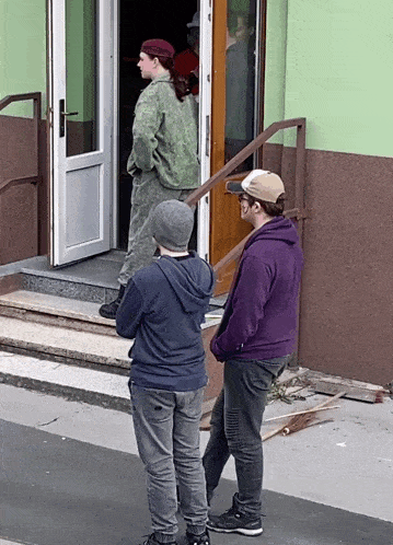 a man in a purple hoodie is standing next to a boy