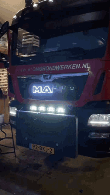 a man truck is parked in a dark garage
