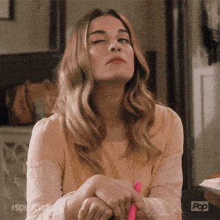 a woman is sitting at a table with her eyes closed and the word pop on the bottom right