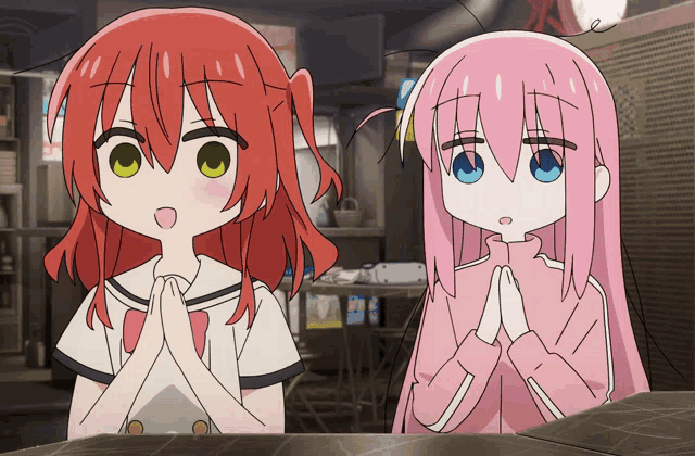 a girl with red hair and a girl with pink hair are praying