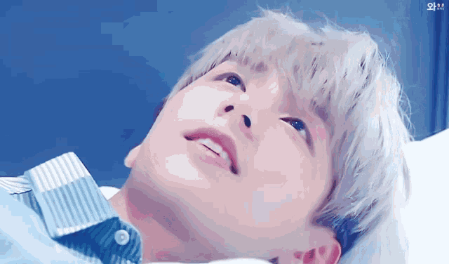 a close up of a person 's face with a blue background that says ' i love you ' on it