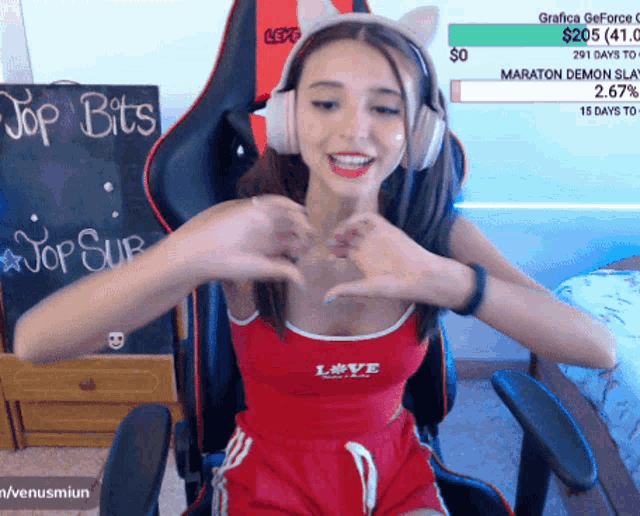 a woman wearing headphones and a red tank top that says love