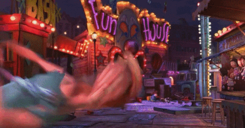 a woman is falling down in front of a fun house sign