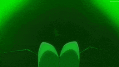 a cartoon character is standing in a dark room with a green light behind him .