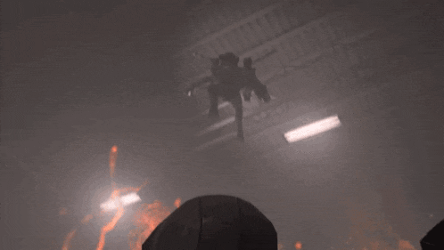 a robot is standing in front of a huge fire