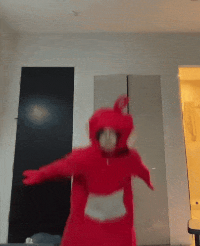 a person dressed in a red teletubbies costume
