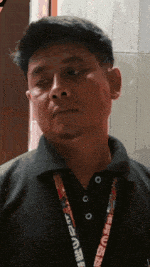 a man with a lanyard around his neck that says ' a ' on it