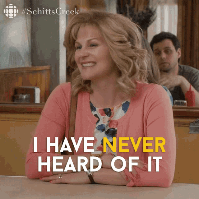 a woman sits at a table with the words " i have never heard of it " on the bottom