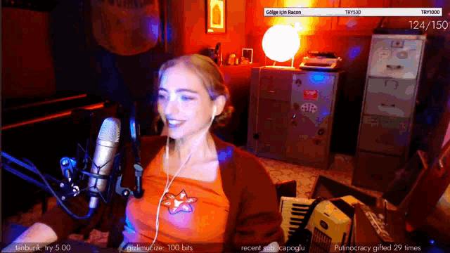 a woman sitting in front of a microphone with the number 124/160 on the bottom right