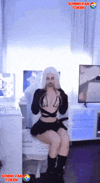 a woman with white hair and a fake mustache is sitting in a chair with sommi fan token written on the bottom