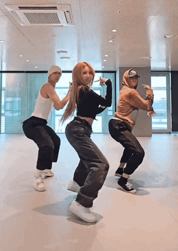 a group of people are dancing together in a room