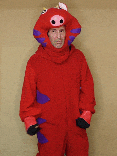 a man in a red costume with purple arms and legs