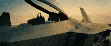 a fighter jet is taking off from a runway with its cockpit open