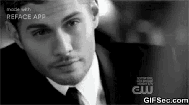 a black and white photo of a man in a suit and tie