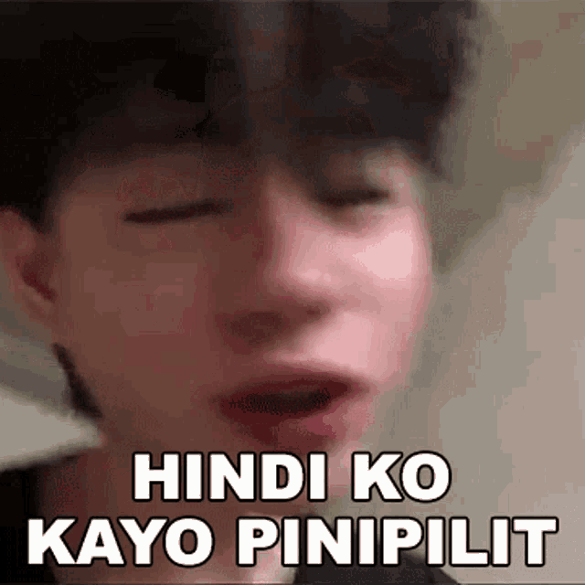 a close up of a person 's face with a sticker that says hindi ko kayo pinipilit .