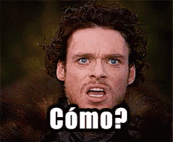 a man with curly hair and blue eyes is making a funny face with the word como on his face
