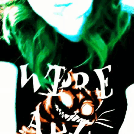 a woman with green hair is wearing a t-shirt that says were all